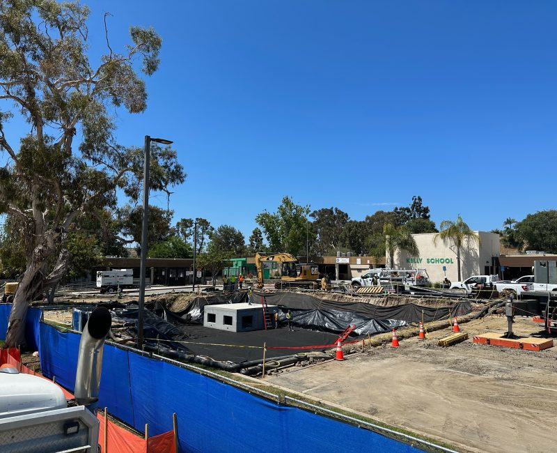 Construction site with blue barriers in front of Valley School.
